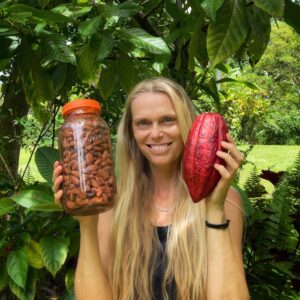 Woman with cacao pod and ferment